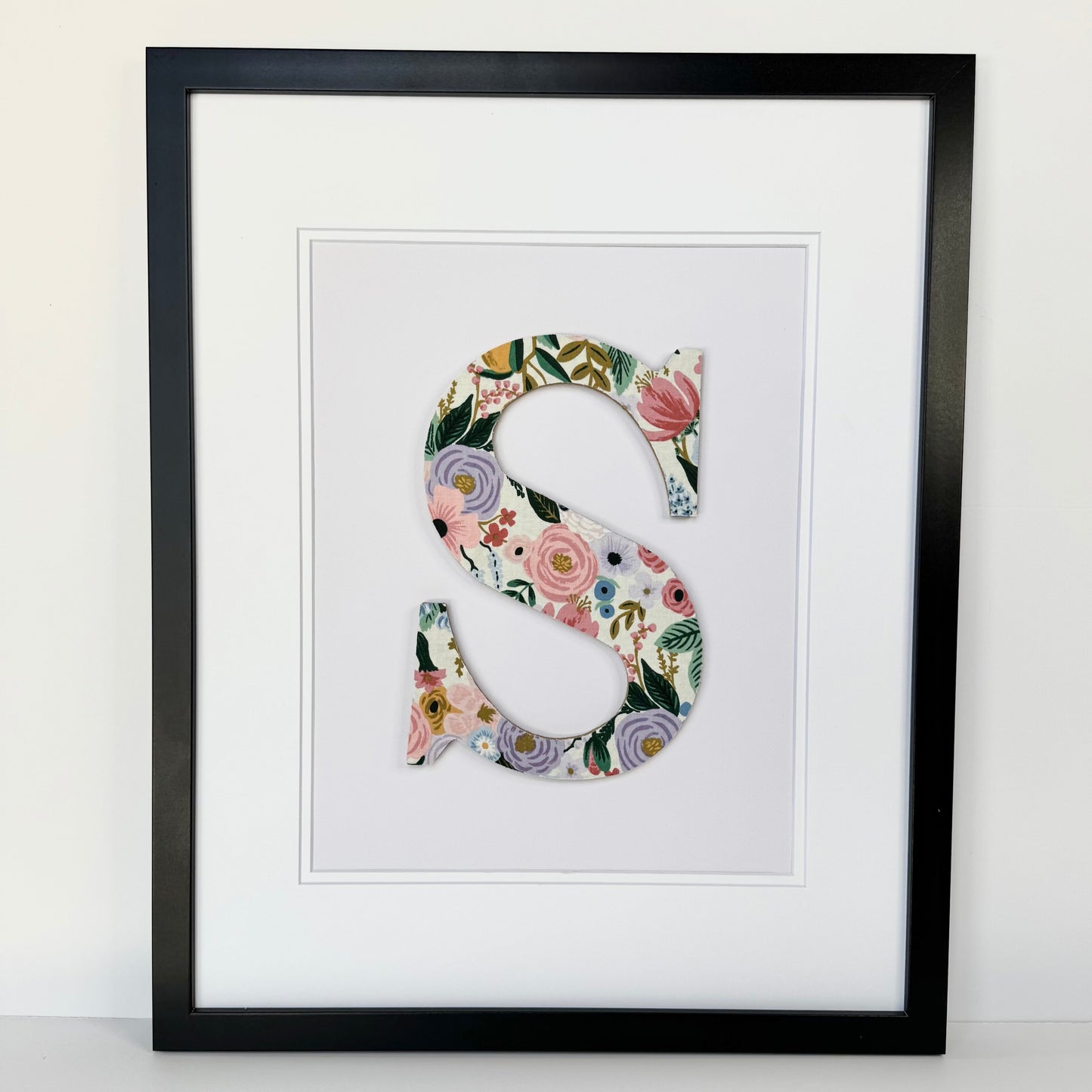 Black Framed letter S with a pink and lavender floral pattern