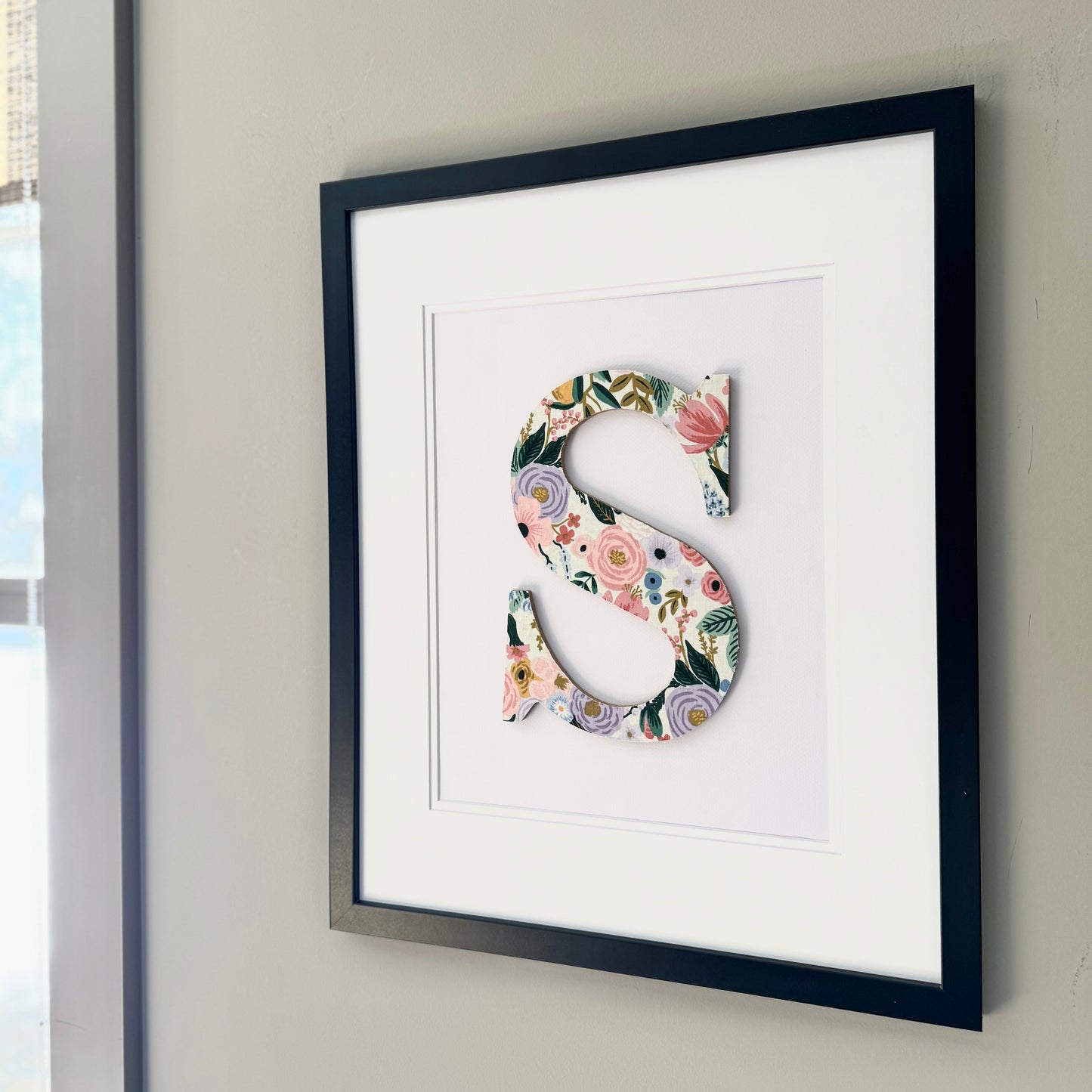 Black Framed letter S with a pink and lavender floral pattern