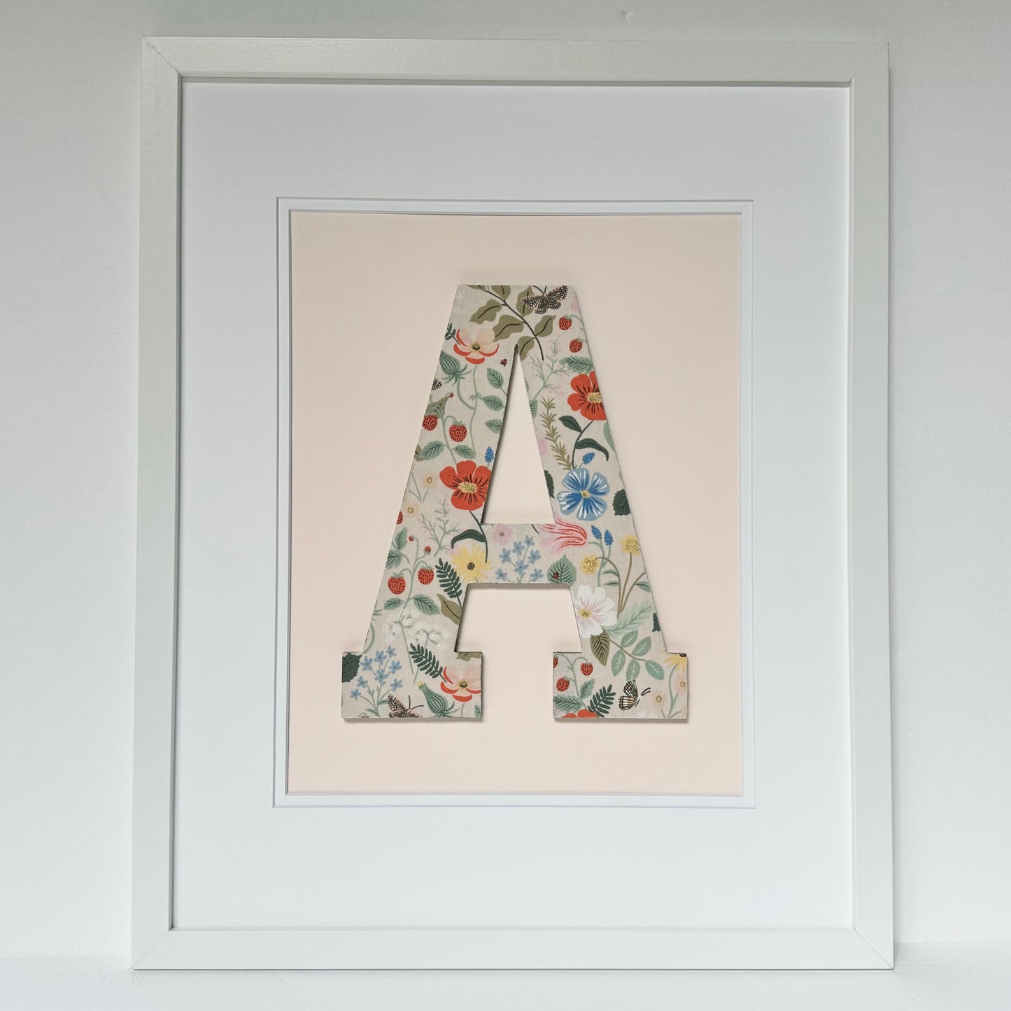 White Framed Strawberry and Flowers print nursery letter A on a pale pink background