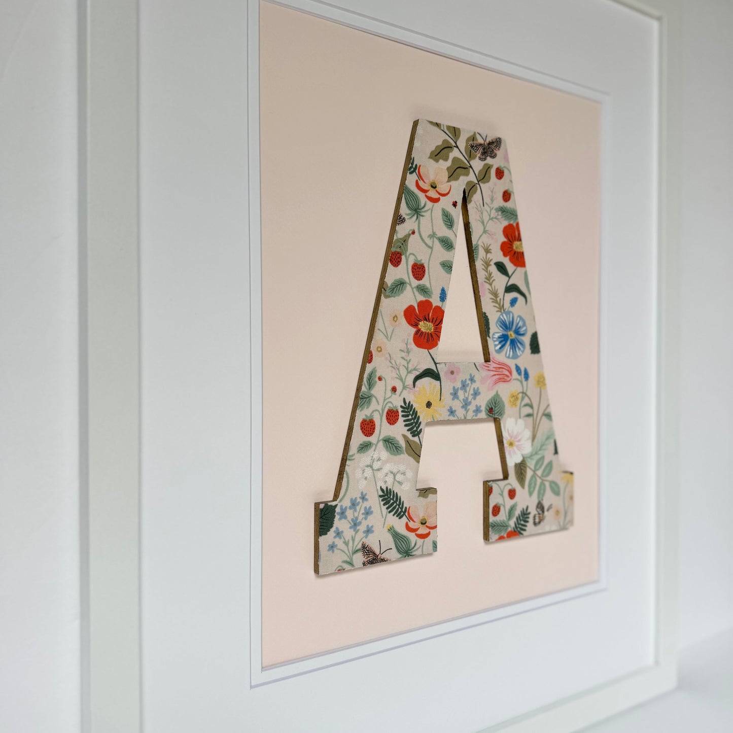 White Framed Strawberry and Flowers print nursery letter A on a pale pink background