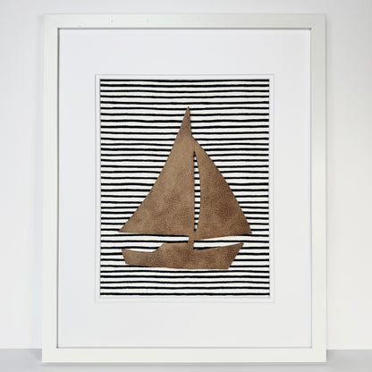 White framed leather sailboat on a navy blue striped fabric background