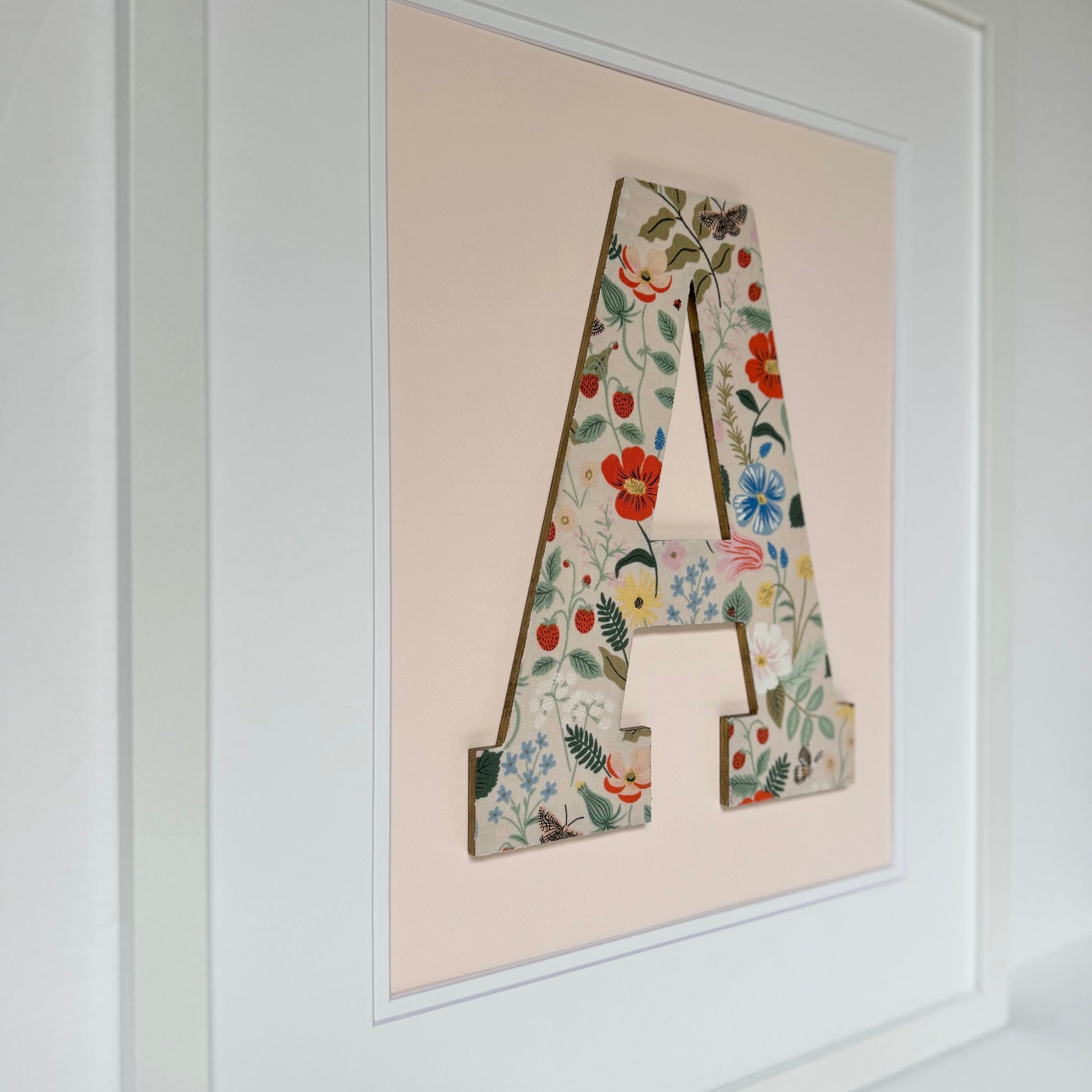 White Framed Strawberry and Flowers print nursery letter A on a pale pink background